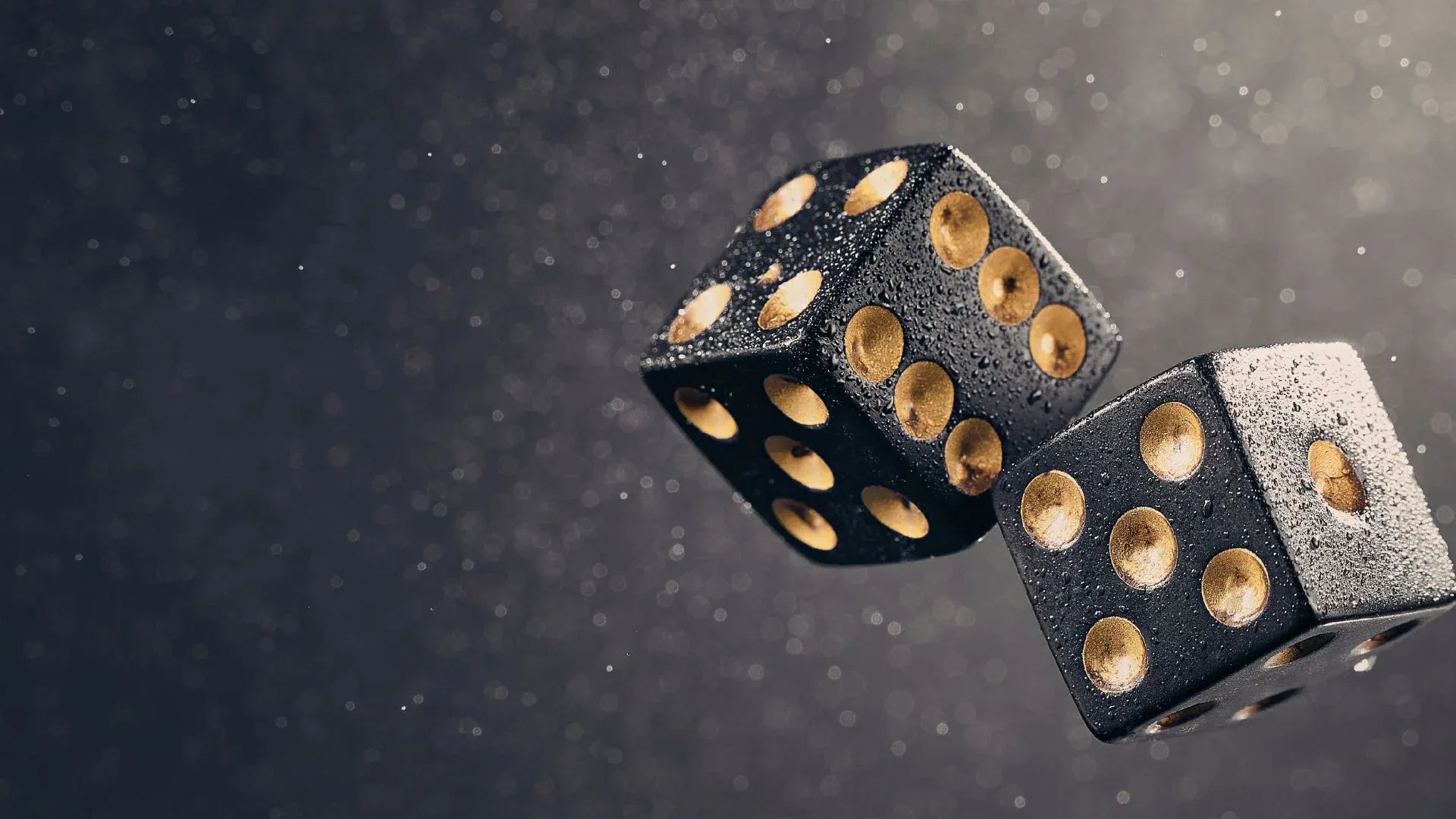 Two black-and-gold dice tossed in the air, used to generate random entropy for a Bitcoin wallet seed phrase